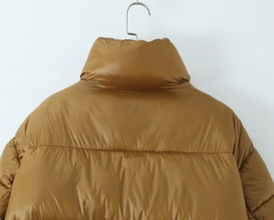 Detail view of mustard yellow puffer jacket with stand collar and horizontal quilting