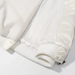 Détails d'une veste en fausse fourrure blanche avec doublure satin et bord-côte