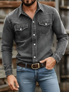 Detail shot of men's washed black denim shirt featuring double chest pockets and buttons