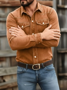 Detail of tan long-sleeve work shirt with double chest pockets and white buttons