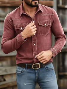 Detail of vintage rust red denim shirt with dual chest pockets and metal buttons