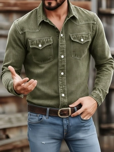 Close-up of military green men's denim work shirt with white buttons and double chest pockets