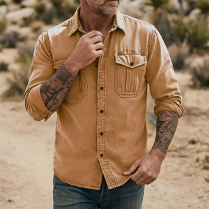 Detail of vintage workwear shirt in earth tone with double chest pockets and metal buttons