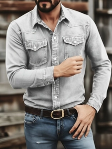 Detail of light gray denim shirt with double buttoned chest pockets and contrast stitching