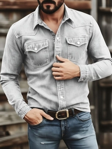 Detail of light grey vintage wash denim shirt with chest pockets and metal buttons