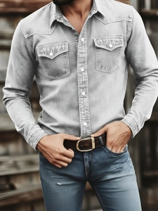 Detail of light grey washed denim shirt featuring double chest pockets and white buttons