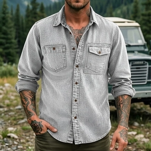 Detail of grey washed denim work shirt featuring dual chest pockets and retro buttons
