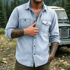 Detail view of light blue denim shirt with dual chest pockets and button-down collar