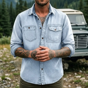 Detail of light blue denim shirt featuring dual breast pockets and wood-style buttons