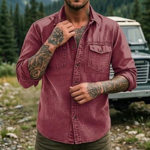Detail of burgundy men's utility shirt with flap pockets in an outdoor setting