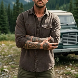 Detail of coffee brown cotton outdoor shirt with buttoned flap chest pockets and washed texture