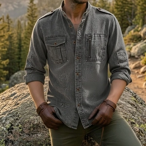 Detail of grey men's utility shirt featuring shoulder straps and dual tactical pockets