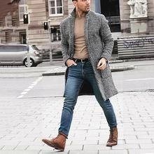 Outdoor street view of a men's mid-length grey plaid wool coat with large flap pockets