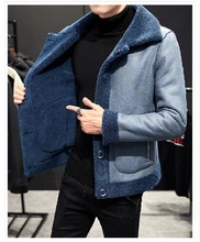 Detail of blue wool blend coat featuring double-breasted lapel and faux fur lining