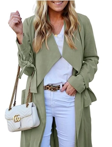 Detail of sage green long trench coat featuring stylish bow-tie cuffs and lightweight fabric