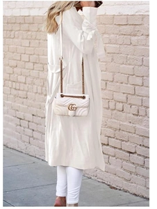 Detail showing white long-sleeve cardigan with stylish bow-knot ties at the cuffs