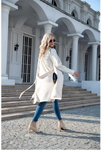 Detail of white mid-length knitted cardigan with waist belt and urban chic casual styling
