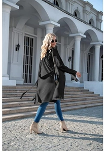 Detail of a chic long black lightweight trench coat with waist belt and long sleeves