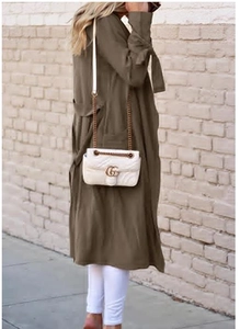 Detail view of the olive green trench coat sleeve with stylish tie-up ribbon cuffs