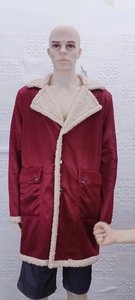 Close-up of men's burgundy suede coat featuring white shearling lining and large pockets