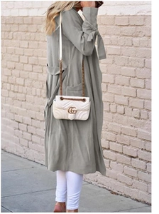 Detail of grey midi cardigan featuring bow-tie cuffs and practical side pockets