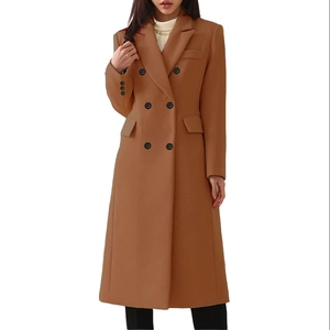 Detail of camel double-breasted long wool coat featuring peak lapels and flap pockets