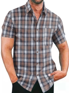 Detailed view of the classic brown and white plaid pattern on men's short sleeve shirt