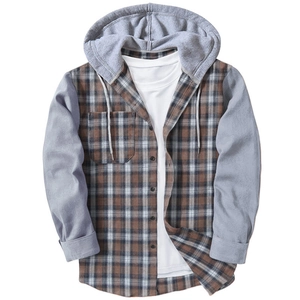 Detail view of hooded plaid shirt featuring grey sleeves and chest pocket on brown grid