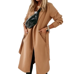 Detail of camel wool coat showing large lapels, side pockets and matching waist tie belt