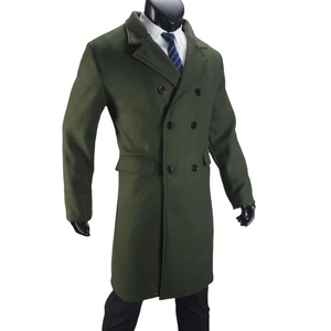 Detailed view of olive green double-breasted wool coat with peak lapels and flap pockets