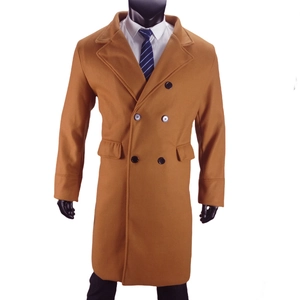 Close-up of double-breasted wool coat with classic lapels and flap pockets in camel