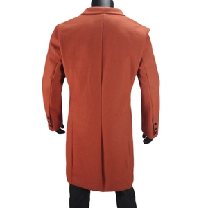 Rear view of rust red wool coat featuring a single back vent and three-button cuffs