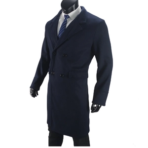 Detail of navy blue double-breasted wool coat featuring notch lapels and flap pockets