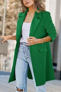 Outdoor shot of a bright green mid-length wool coat with notched lapels and flap pockets