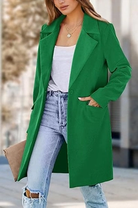 Outdoor street style shot of a long green wool coat with a single button and lapel