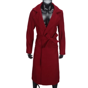 Detail of burgundy wool long coat featuring lapel collar and waist tie on mannequin