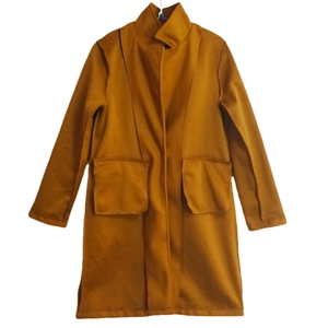 Detailed view of women's ginger yellow wool coat with large square pockets and high collar
