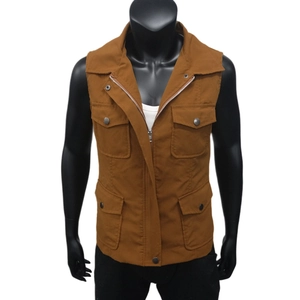 Detail of a brown utility vest with large flap pockets and metal zipper closure