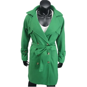 Détail d'un manteau vert en laine avec revers classiques, double boutonnage et ceinture