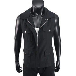 Close-up of black utility vest with four cargo pockets and functional zipper details