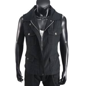 Detail of black tactical utility vest with four flap pockets and silver metal snap buttons