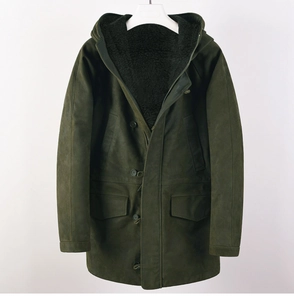 Detail of olive green parka jacket showing warm black fleece lining and durable hooded design