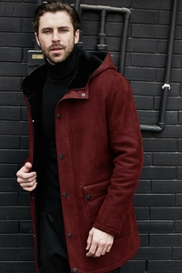 Detail of burgundy faux suede parka featuring thick black faux fur lining and hood