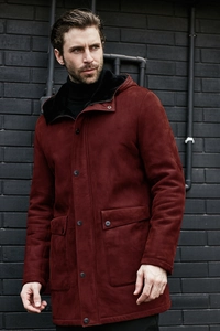 Detail of burgundy faux suede jacket with warm black faux fur lining and hood