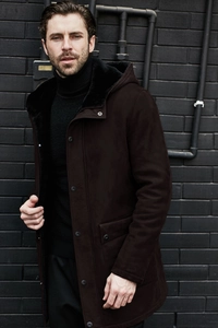 Close-up of men's suede parka featuring warm black faux fur lining and hooded design