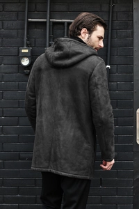 Macro shot of dark grey faux suede texture and premium stitching on hooded jacket