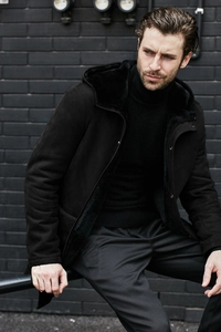 Detail shot of men's hooded faux fur lined jacket in black suede showing winter texture