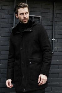 Detail view of black faux suede hooded jacket featuring large pockets and plush warm lining