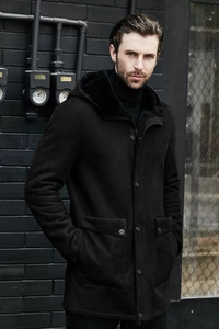 Close-up of black hooded faux suede coat with thick plush lining and flap pockets