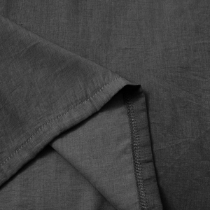 Macro view of dark grey fabric texture with durable double stitching on casual t-shirt